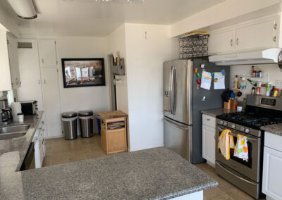 A nice kitchen with oven stove , stainless steel refrigerator and granite coutnertops