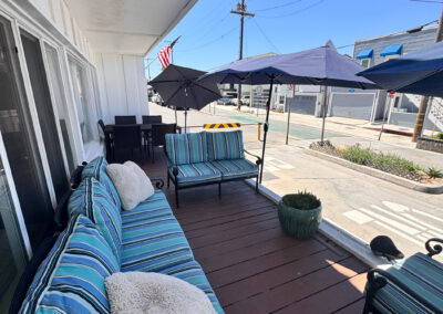 A deck with nice patio furniture and umbrellas