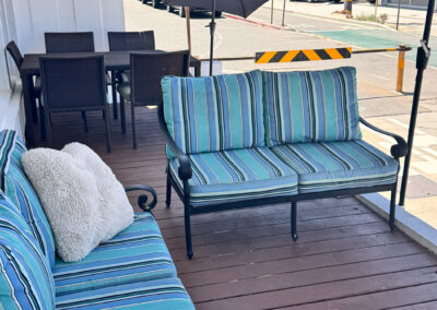 A deck with nice patio furniture and umbrellas