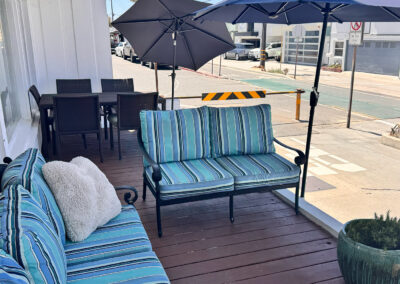 A deck with nice patio furniture and umbrellas